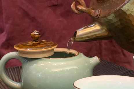 Pouring Taiwanese oolong tea in a clay cup