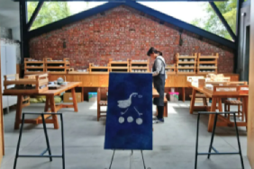Hand painting a cat on a ceramic dish